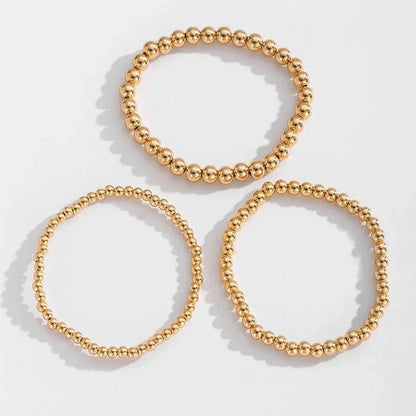 Set de 7 pulseras doradas de cuentas apilables
